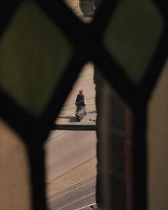 a person walking down the street through a window