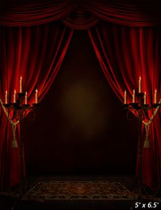 a stage with red curtains and lit candles