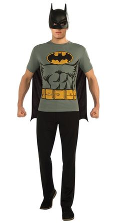 a man wearing a batman t - shirt and black pants with his hands on his hips