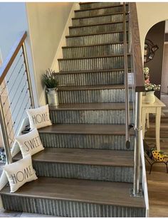 a set of stairs leading up to the second floor with decorative pillows on each step