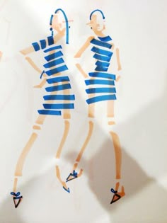 two paper cut out of people wearing blue and white outfits