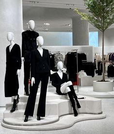 three mannequins dressed in black and white outfits