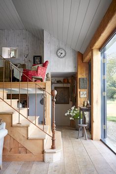 there is a staircase leading up to the second floor in this modern home with wood paneling and white walls