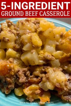 a blue plate topped with ground beef casserole next to a red and white sign