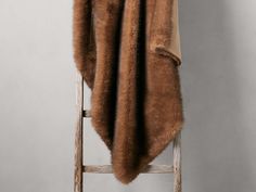 a chair with a fur coat on top of it