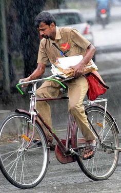 a man riding a bike in the rain