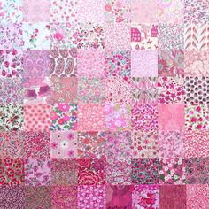 a pink patchwork quilt with lots of different colors and patterns on the fabric,