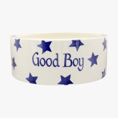 a blue and white bowl with stars on it that says good boy in the center