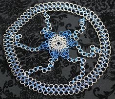 This chainmail headdress is made from several sizes of blue anodized and aluminum rings in a  European weave. It is very light and will fit most adult sizes.  It is shown on a 20 inch model head and should fit up to a 24 inch (61 cm) head or so.  It's actual circumference is about 25 inches (64 cm) around. Chainmail Headpiece, Chainmail Headdress, Joan Of Arc Costume, Chainmail Patterns, Head Gear, Chain Maille, Joan Of Arc, Pattern Ideas, Chain Mail