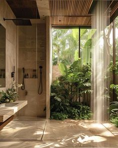 a bathroom with large windows and lots of greenery in the shower area is shown