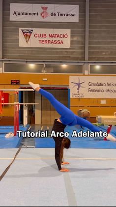 a woman doing a handstand on the floor