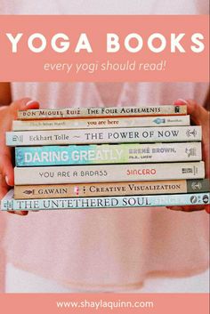 a woman holding a stack of yoga books in her hands with the words, yoga books every yogi should read