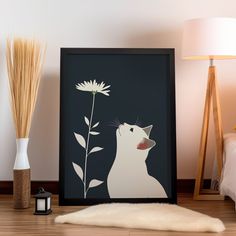 a white cat is looking at a flower