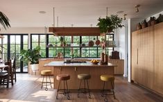 a kitchen with wooden floors and lots of plants