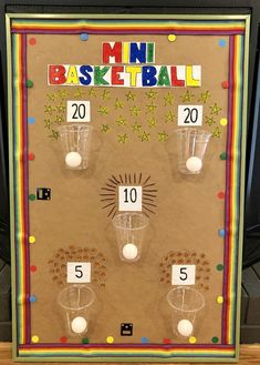 a bulletin board with cups and balls on it for numbers to match the basketball game