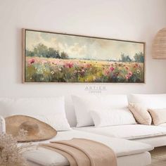 a living room filled with furniture and a painting on the wall above it's couch