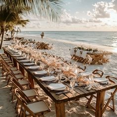 a long table set up on the beach for dinner