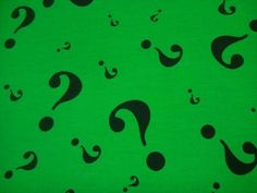 a green background with black question marks on it