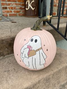 a painted pumpkin with a ghost on it