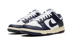 Elevate your sneaker game with these Nike Dunk Low Vintage Navy sneakers in size 10.5W/9M. The low top shoe shaft style provides a sleek and stylish look, perfect for any casual occasion. The blue colorway and W shoe width make these sneakers a must-have for any fashion-forward woman. Made with quality materials, these Nike Dunk Low sneakers are designed to last. The FN7197-100 style code and Nike Dunk product line ensure that you're getting a top-notch product from a trusted brand. Perfect for Nike Dunk Low Vintage Navy, Blue Dunks, Nike Heels, School Pack, Retro Basketball Shoes, Nike Branding, Navy Sneakers, Retro Basketball, Nike Brand