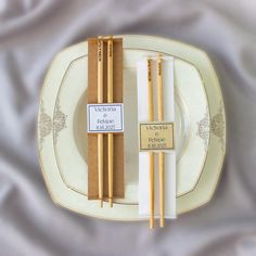 two chopsticks are sitting on a plate next to each other with labels that read victoria palace