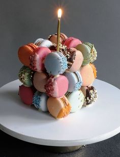 a white plate topped with a cake covered in lots of different types of candies