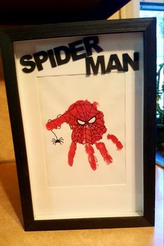 a spiderman handprint is displayed in a frame