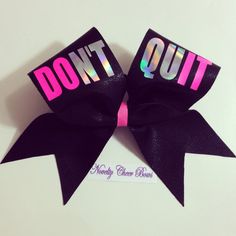 two bows with the words don't quit in pink and purple on them, sitting next to each other