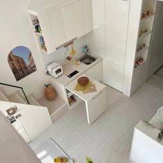 an aerial view of a kitchen and living room from the top floor to the ceiling