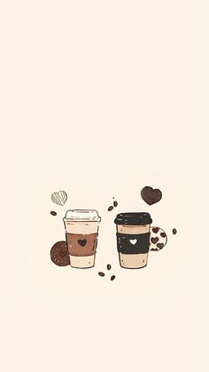 two coffee cups with hearts on them sitting next to each other