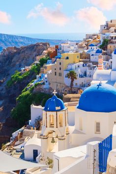 an image of a blue and white church on the cliff