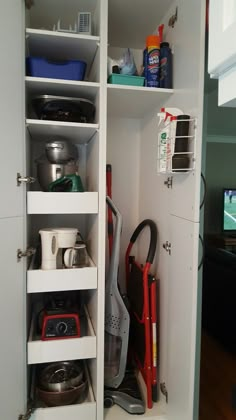 an open cabinet with many items in it