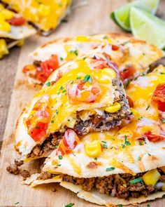 two quesadillas stacked on top of each other with cheese and toppings