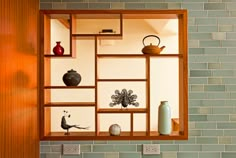 an open window with vases and other decorative items on the shelf in front of it