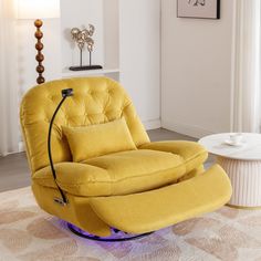 a yellow recliner chair sitting in a living room next to a white coffee table