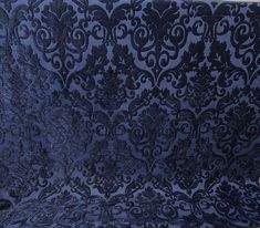 an ornate blue fabric with black flowers on it