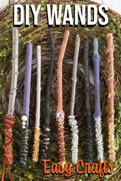 a bunch of different colored candles sitting on top of a wicker basket filled with ivy