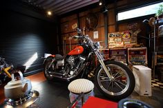 a motorcycle is parked in a garage next to other motorcycles and accessories on display at the store