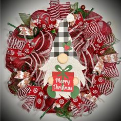 a christmas wreath with a red and white ornament