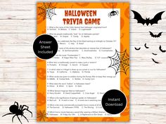 a halloween trivia game is shown on a wooden table with bats and pumpkins