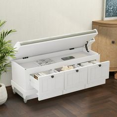 a white wooden storage bench with drawers on the bottom and one open drawer below it