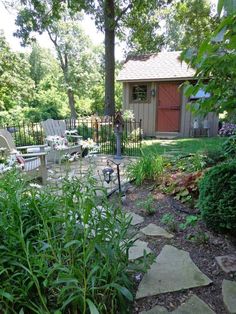 a garden with lots of plants and chairs