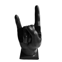 a black and white photo of a hand making the peace sign