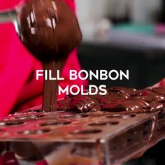 a person pouring chocolate into a tray with the words fill bonbon molds on it