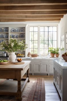 Kitchen Design - Charming Kitchen - Natural Light - Blue Kitchen - Rustic Kitchen - FHL Design Studios - Wood Floor Kitchen - Tall Windows - Windows in Kitchen - Wood Beams Kitchen - AI Genertated - AI Kitchen Design - White Kitchen - Vintage Rug - Wooden Kitchen Island French Kitchen Dining Room, Country Craftsman Kitchen, Kitchen With Tall Windows, Wood Beams In Kitchen, Beams Kitchen, Rustic French Home, English Interior Design, Kitchen Natural