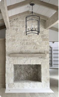 a fireplace with a light fixture hanging from it's side