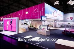 an exhibit area with pink and white displays on the walls, flooring and lighting