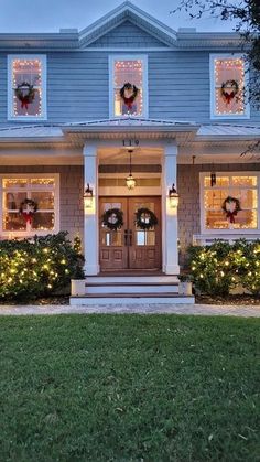 a house decorated for christmas with wreaths and lights