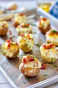 baked potatoes stuffed with bacon and cheese on a baking sheet, ready to be eaten