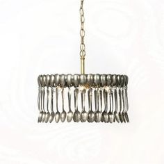 a chandelier hanging from a chain on a white wall